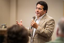 Alberto Gonzalez lectures in front of audience